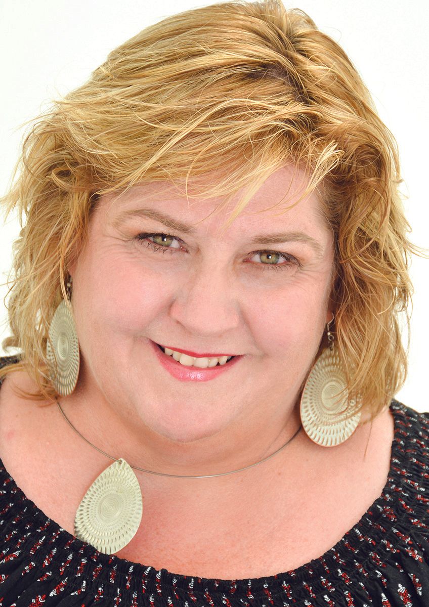 headshot of professional middle aged woman smiling