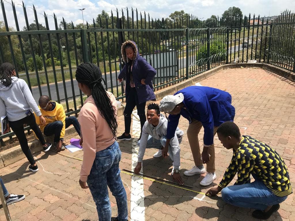 group of students measuring paving on he ground
