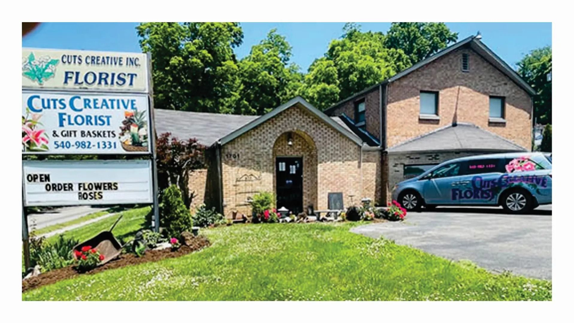 Cuts Creative Florist storefront with sign, brick building, green grass, and a floral delivery van.