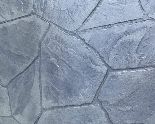 A close up of a gray stone floor with a geometric pattern