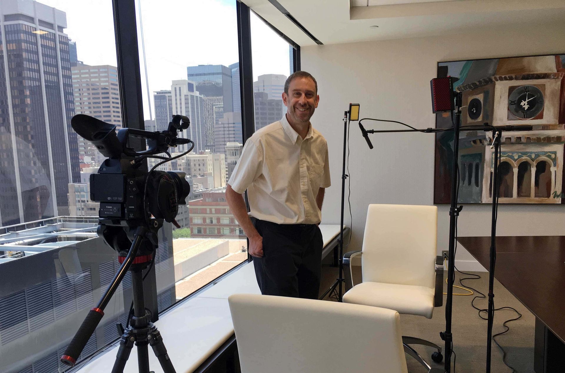 A man is standing in front of a camera in a room