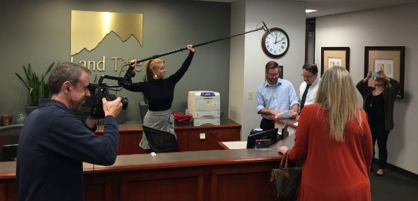 A woman is giving a speech in front of a crowd at a conference.
