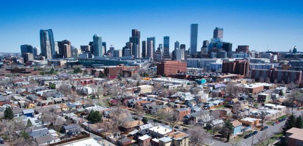 An aerial view of a city with a skyline in the background