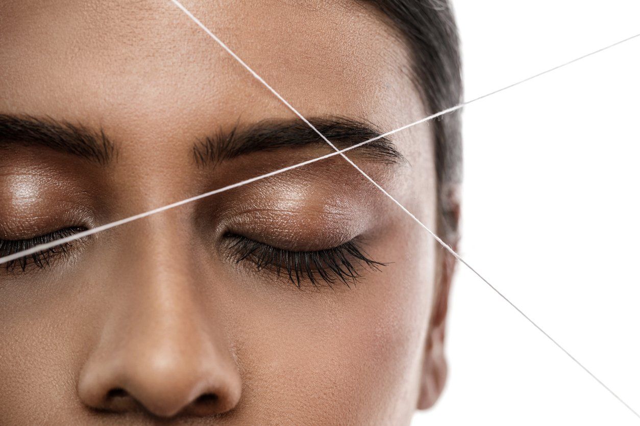 woman-getting-an-eyebrow-threading-treatment