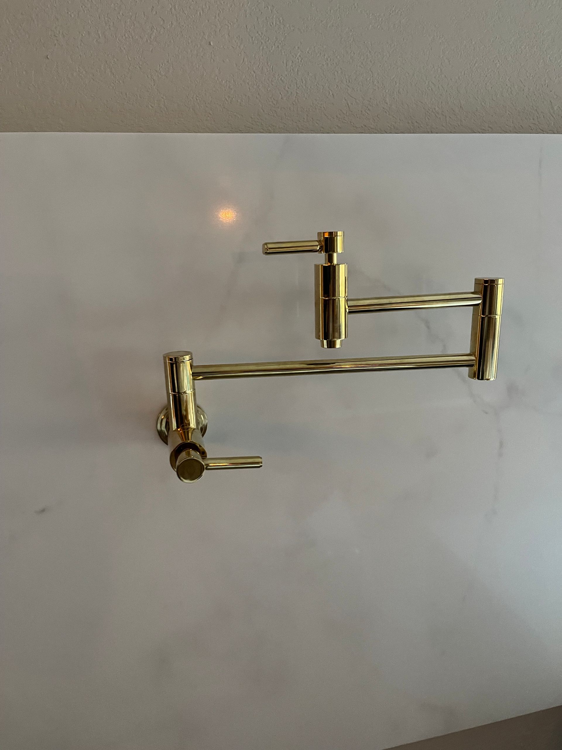 plumber fixing white sink pipe with adjustable wrench