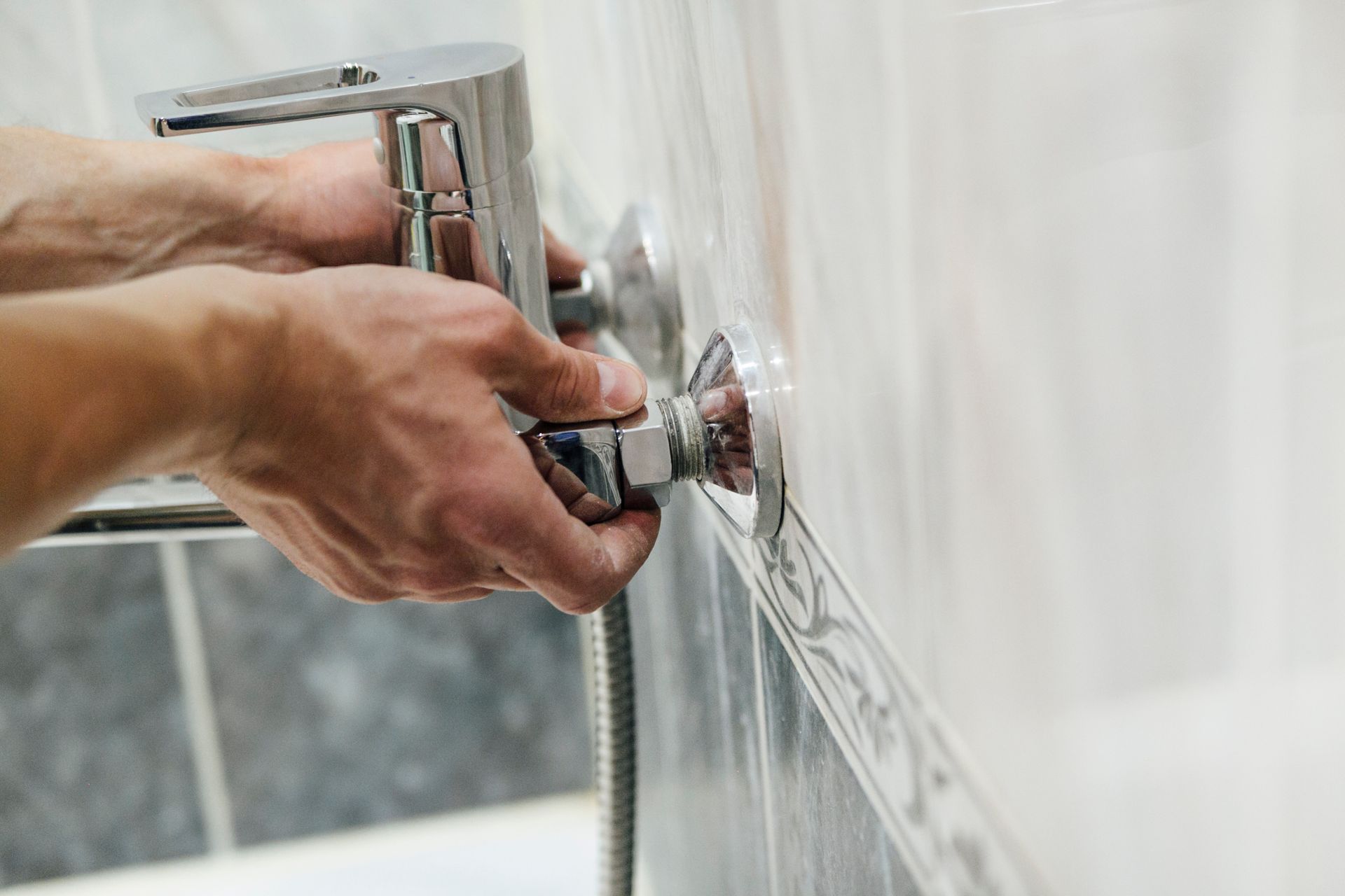 man repairs faucet bathroom