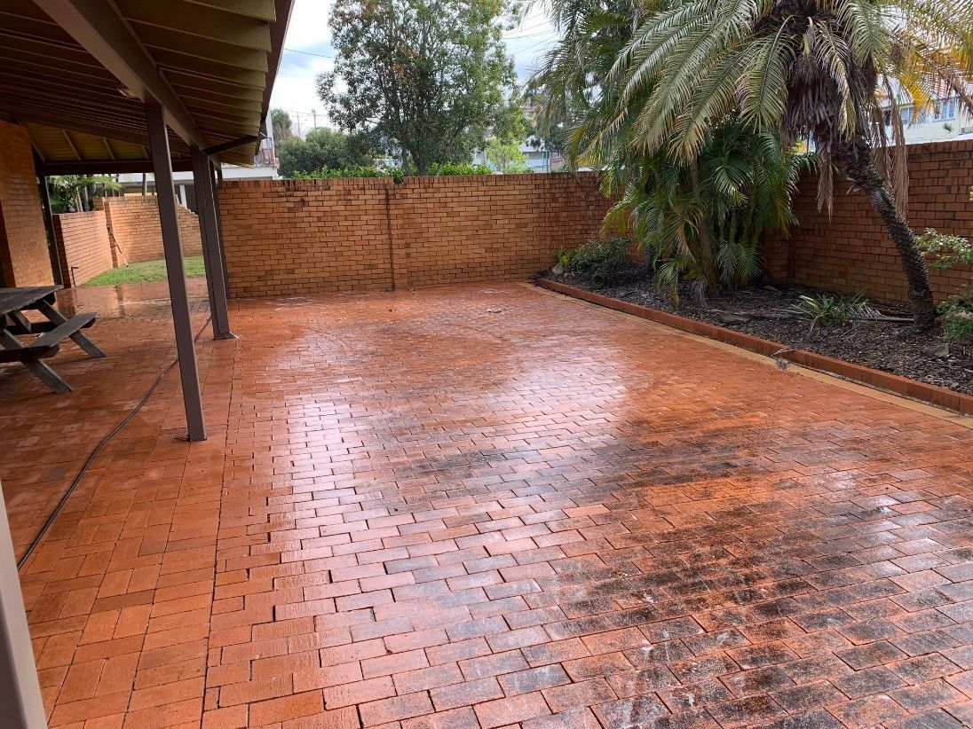 A Brick Floor Undergoing Pressure Cleaning