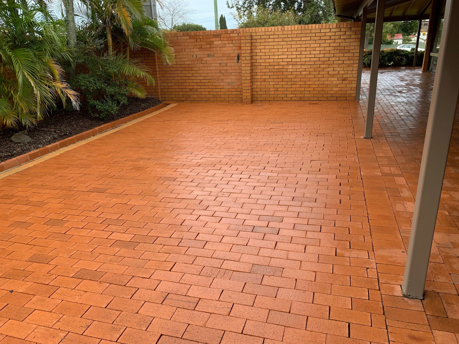 Red Brick Patio With Brick Wall and Covered Walkway — Complete Pressure Cleaning in Glen Port Macquarie, NSW