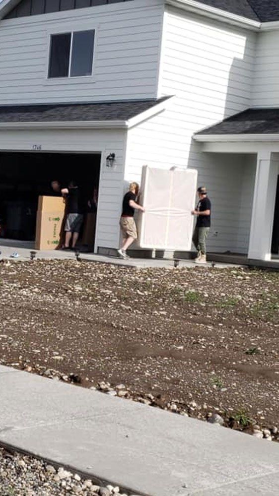 Men Moving the Furniture Inside the House — Belgrade, MT — Rock Steady Movers