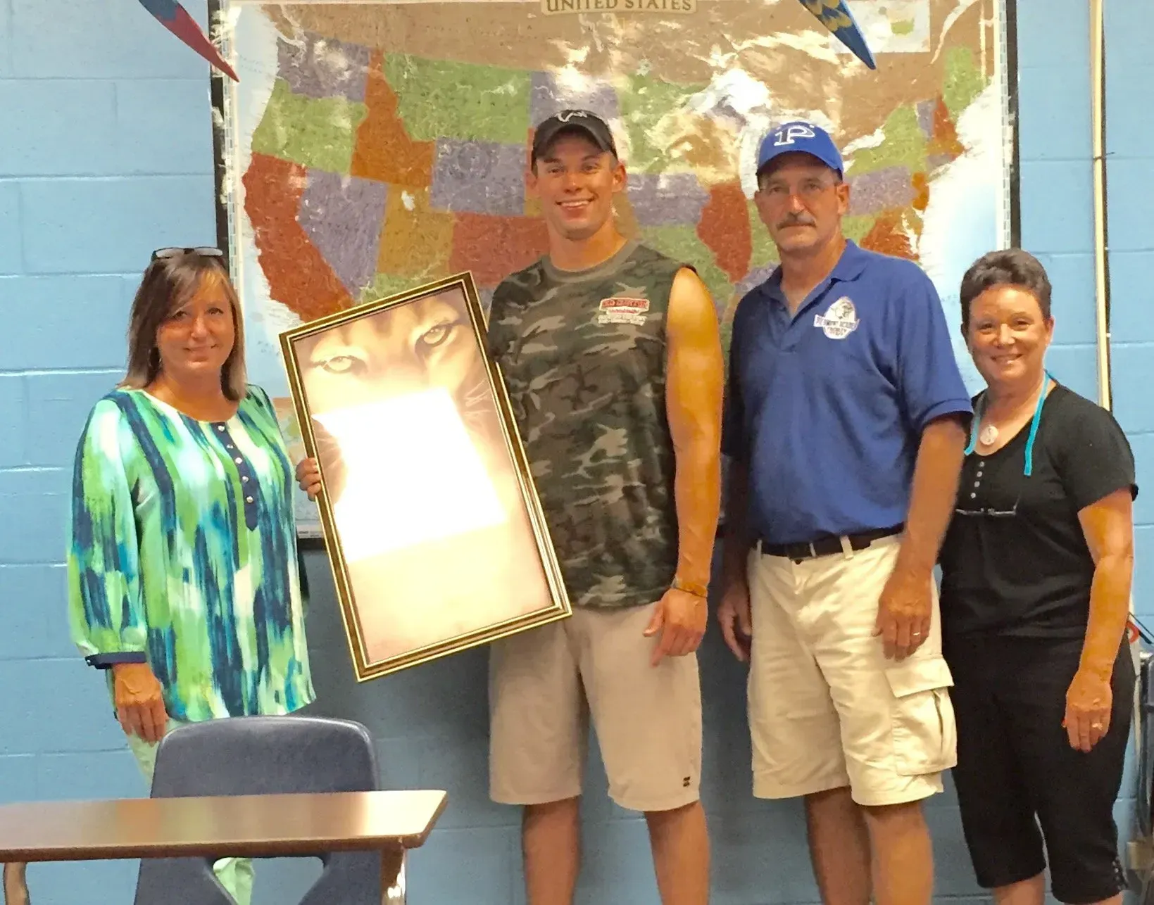 A group of people standing in front of a map of the united states