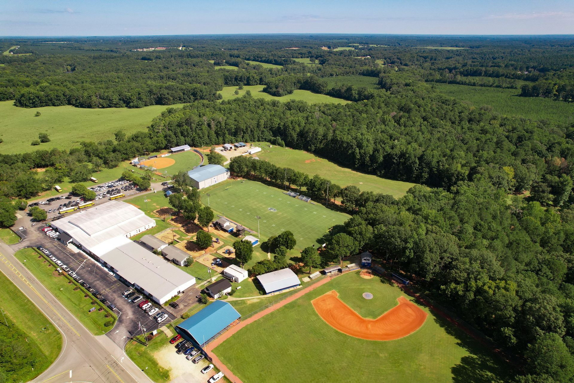 An aerial view of a baseball field surrounded by trees.