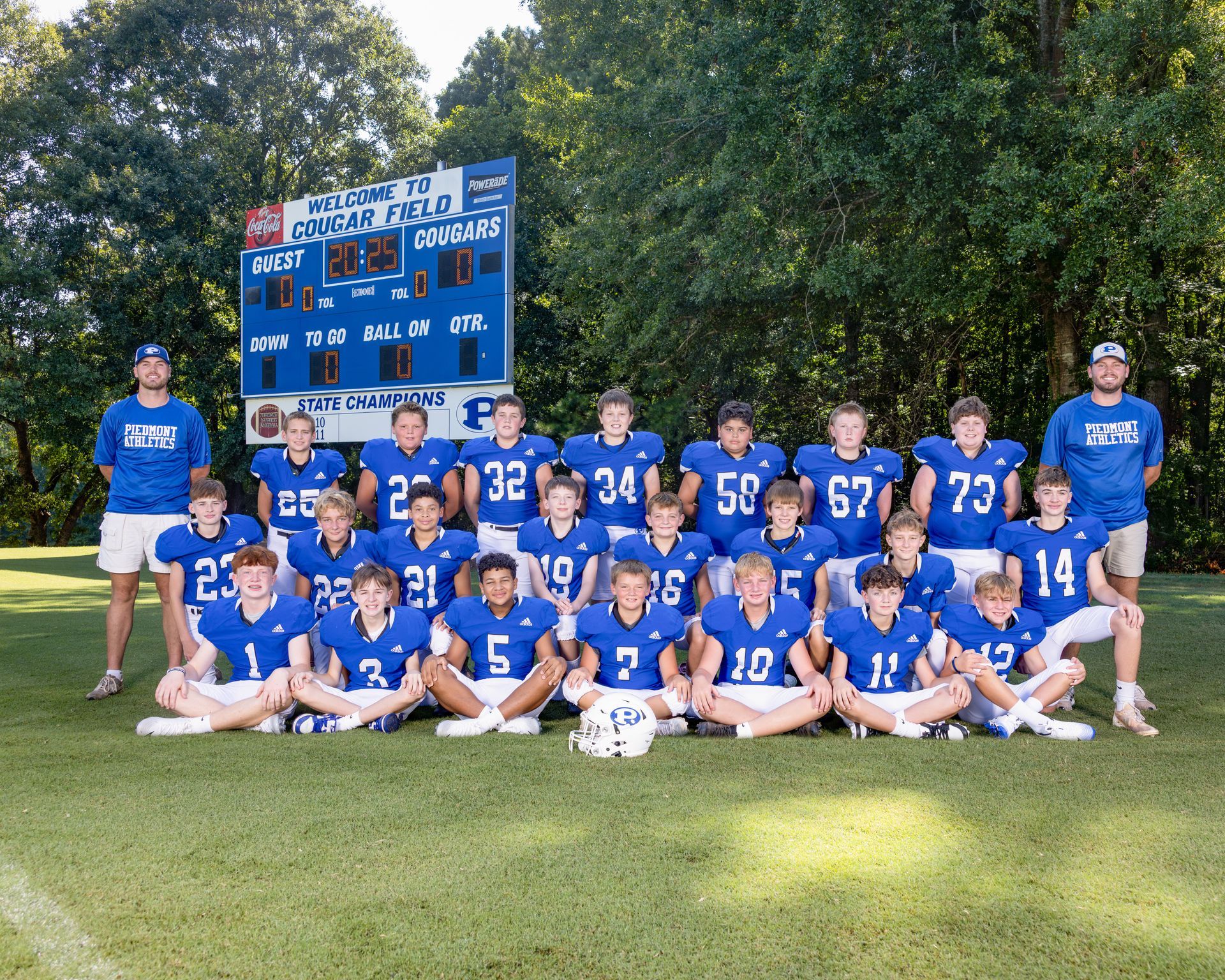 A group of young boys are posing for a football team photo.