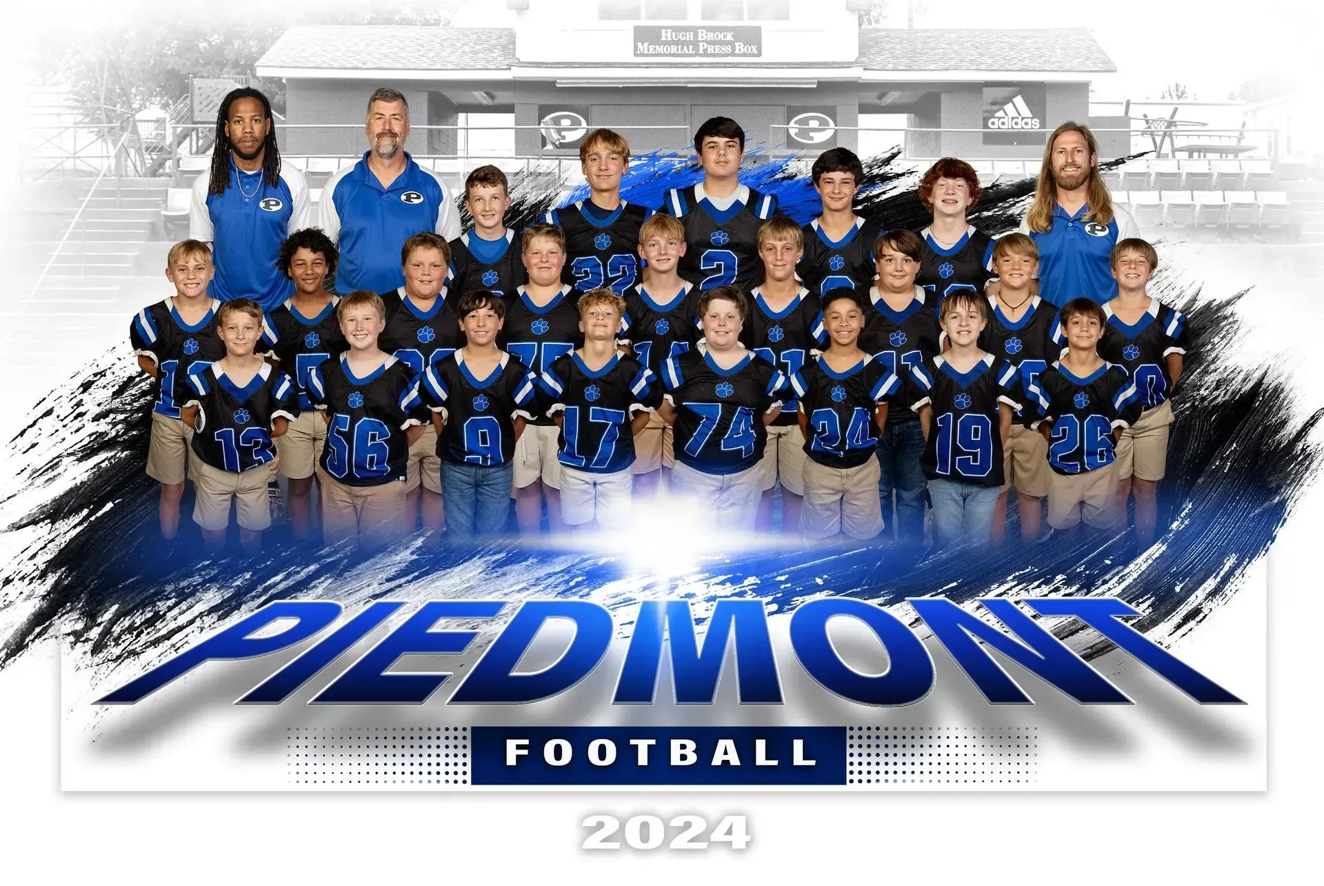 A group of young boys are posing for a football team photo.