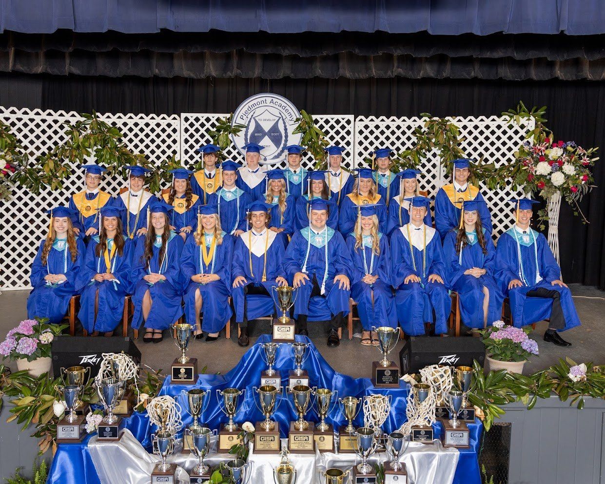 A group of graduates are posing for a picture
