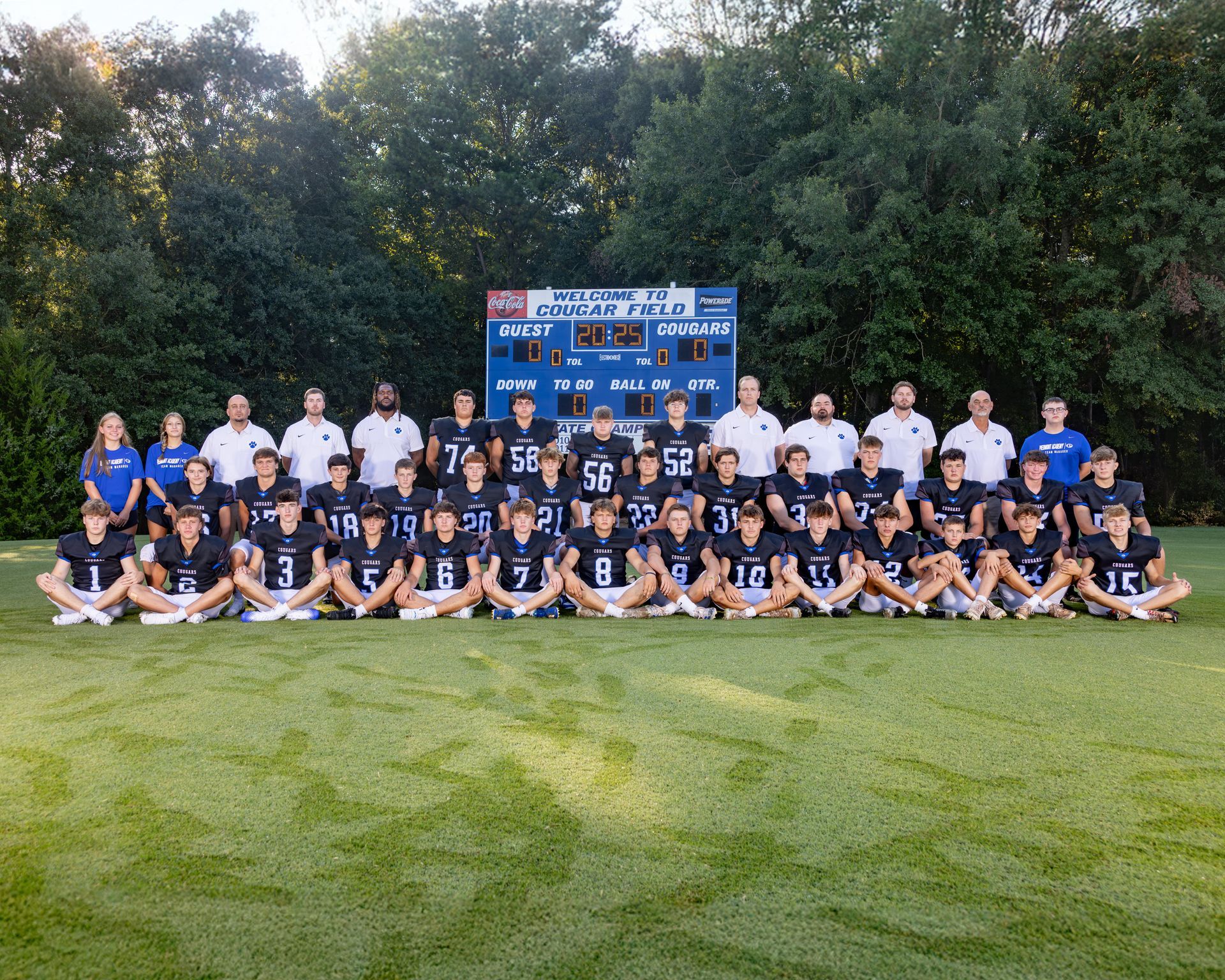A group of football players are posing for a team photo.