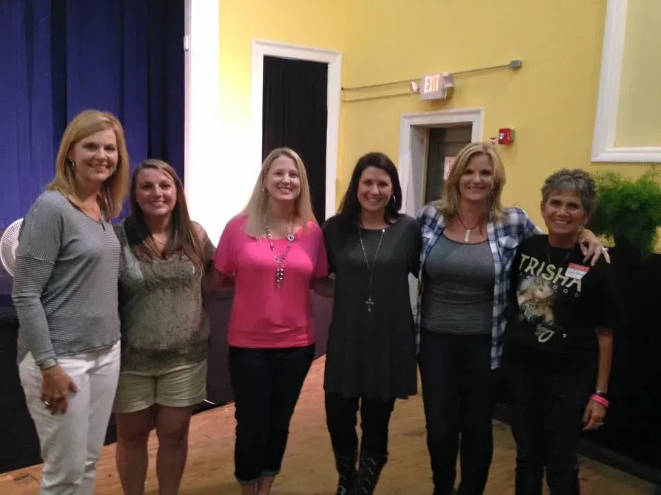 A group of women are posing for a picture together.