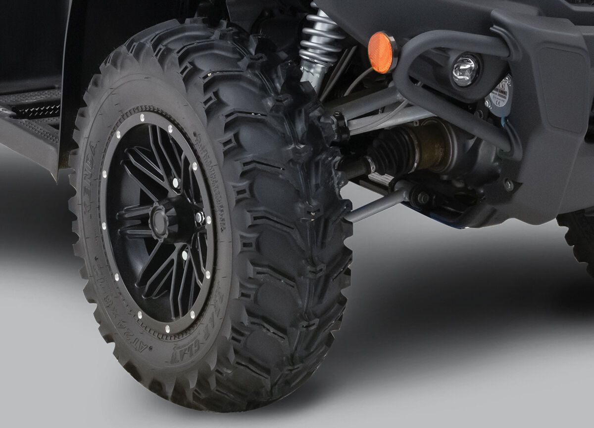 A black, rugged looking ATV tire.