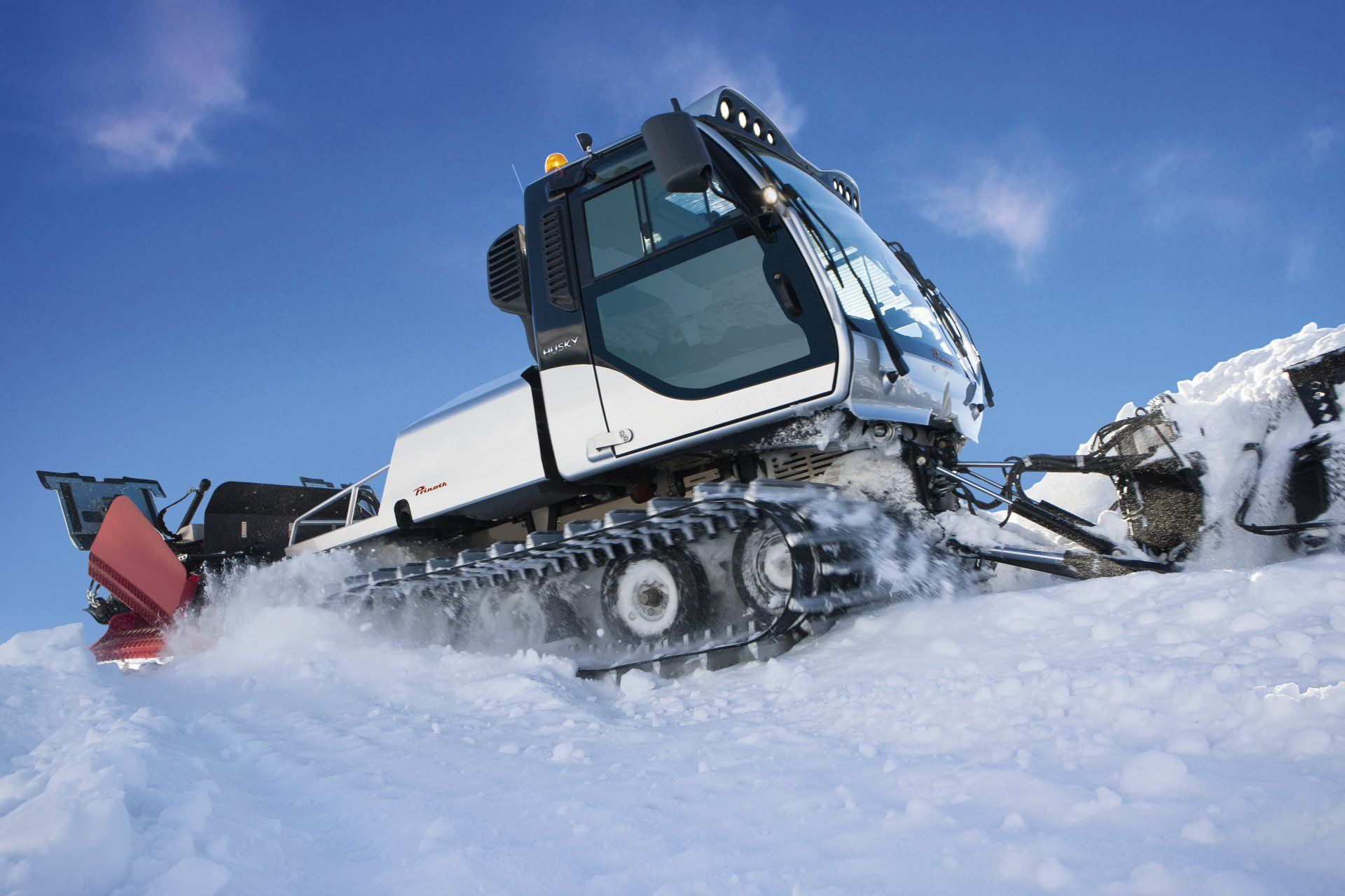 A Prinoth Husky plowing the snow.