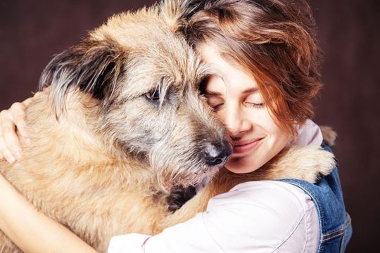 woman hugging her dog