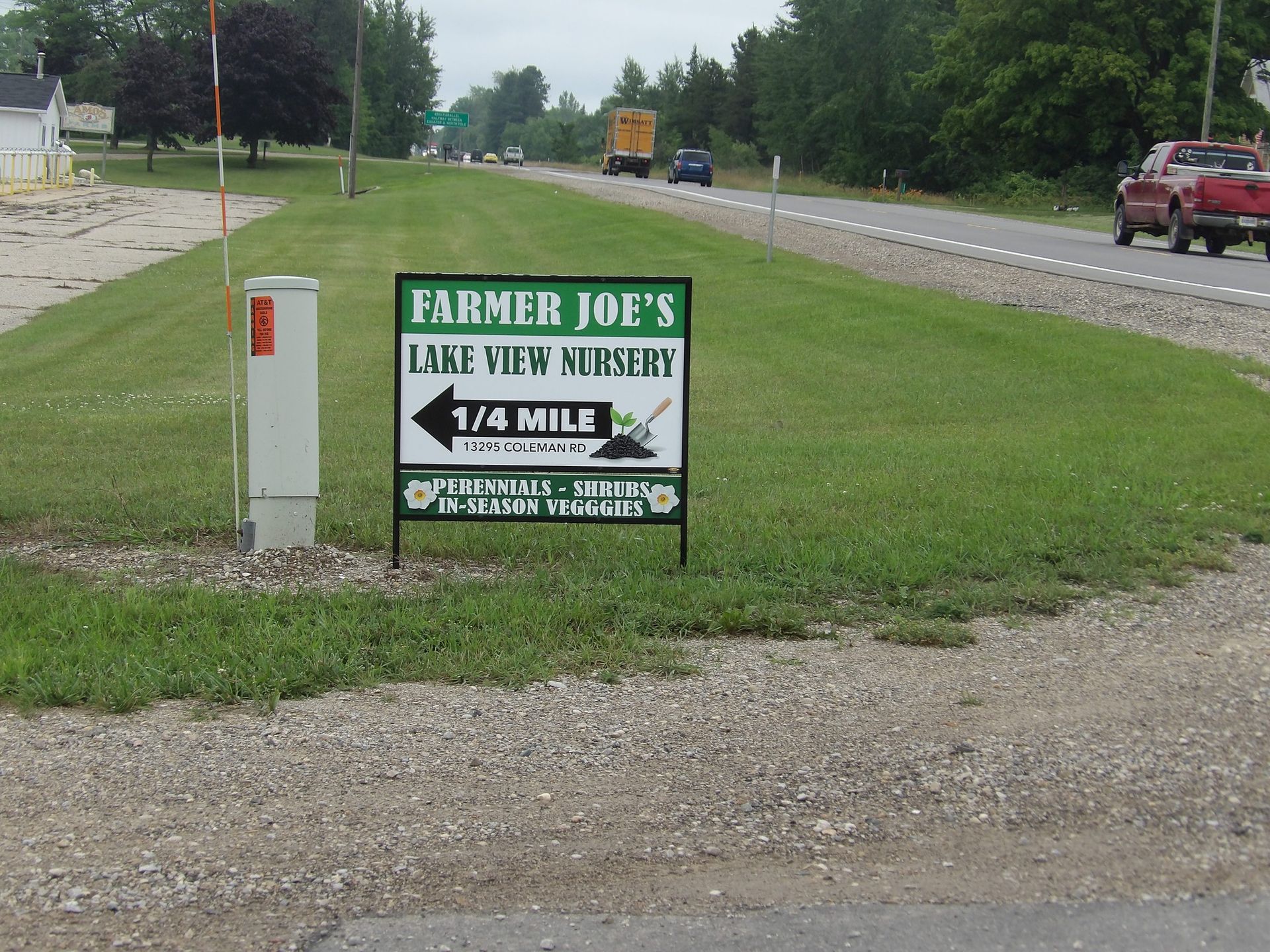 A sign for farmer joe 's lake view nursery is on the side of the road