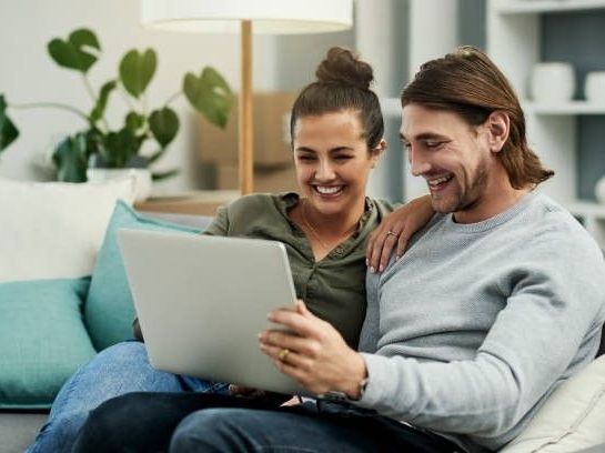 Young couple looking at new homes online from the sell south florida team