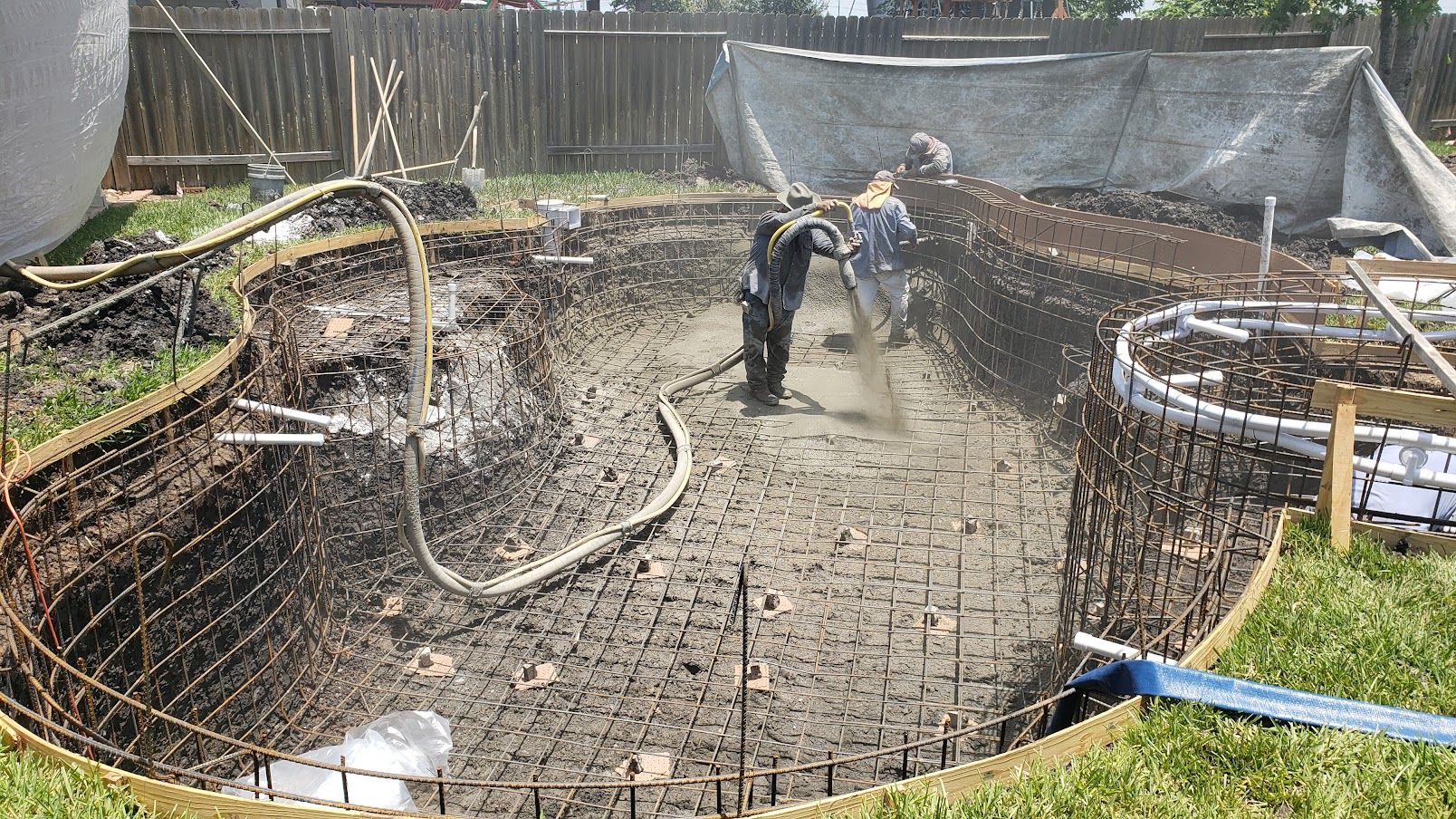 A large swimming pool surrounded by palm trees in a resort.