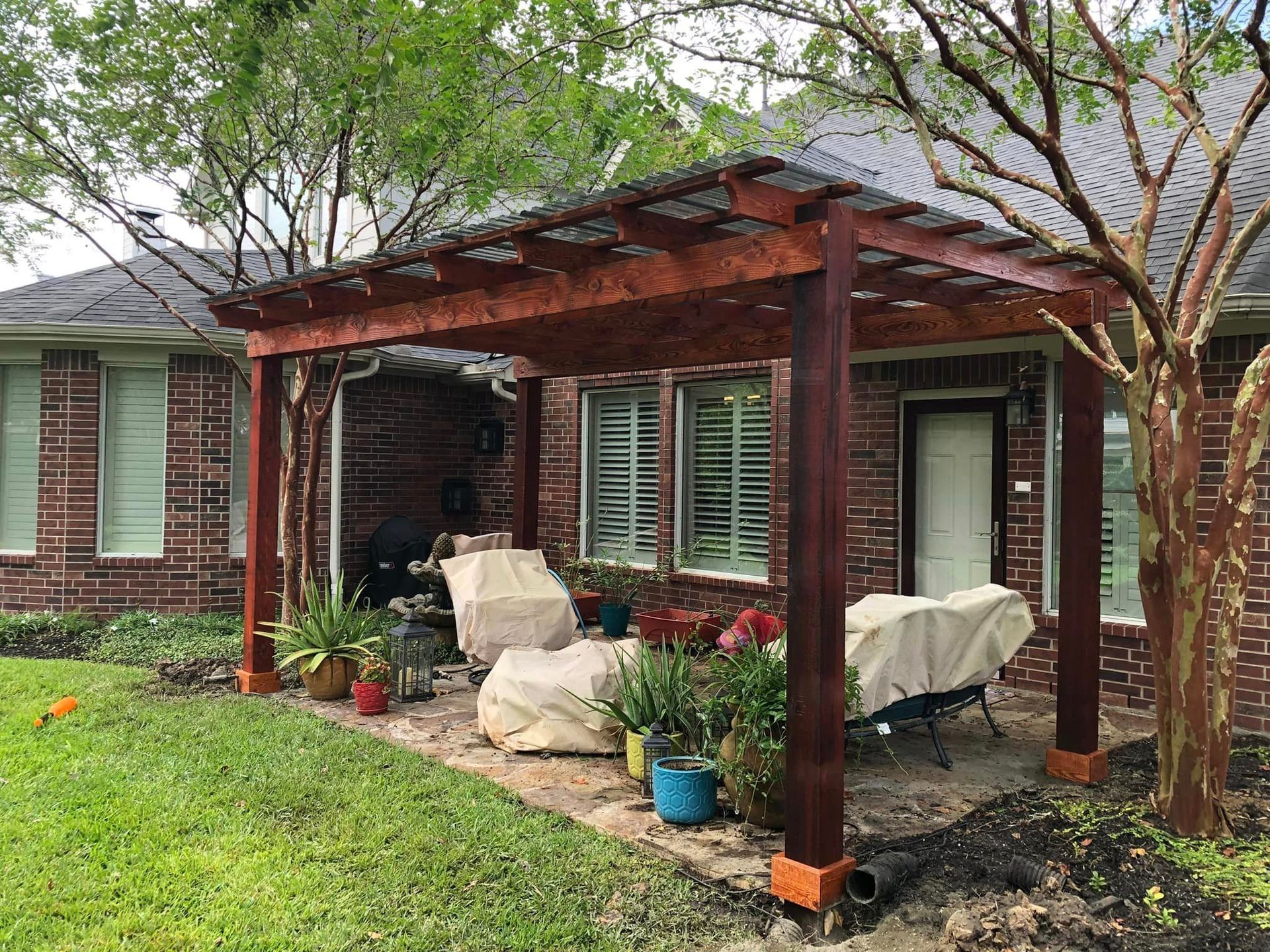 A bunch of grapes hanging from a wooden pergola
