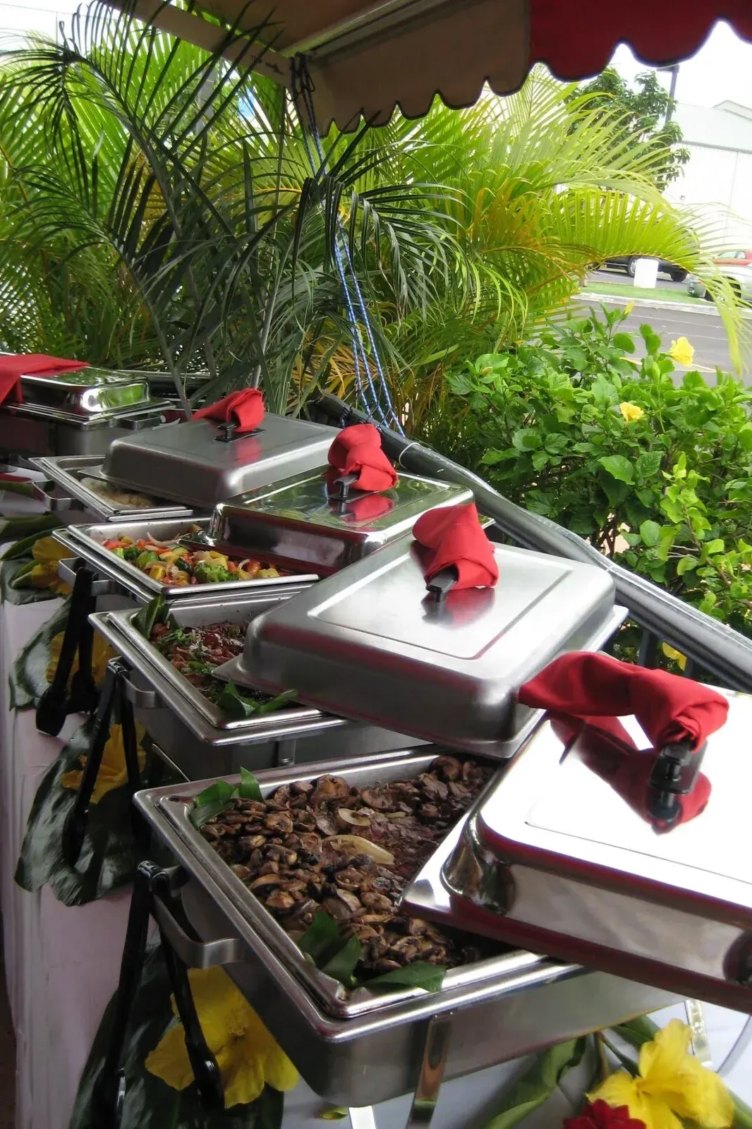 Buffet table with various dishes: salads, meats, and vegetables.