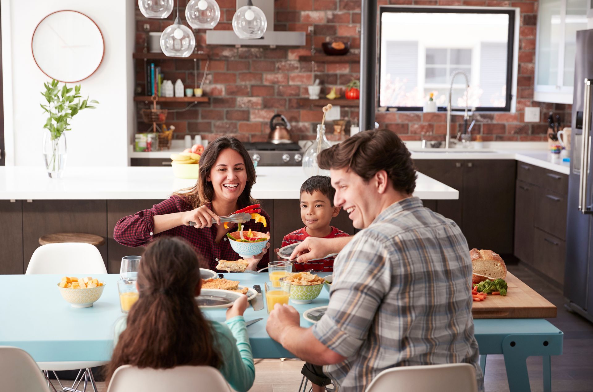 A family enjoying dinner in their remodeled kitchen.