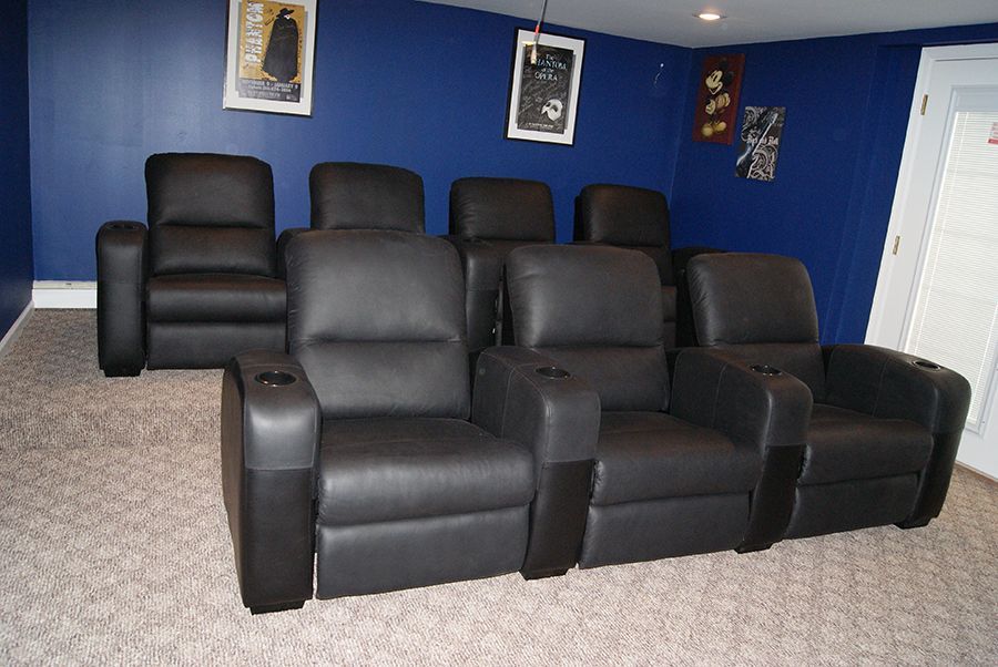 Red brick house with a white-framed glass extension, red tiled roof, and a green lawn.