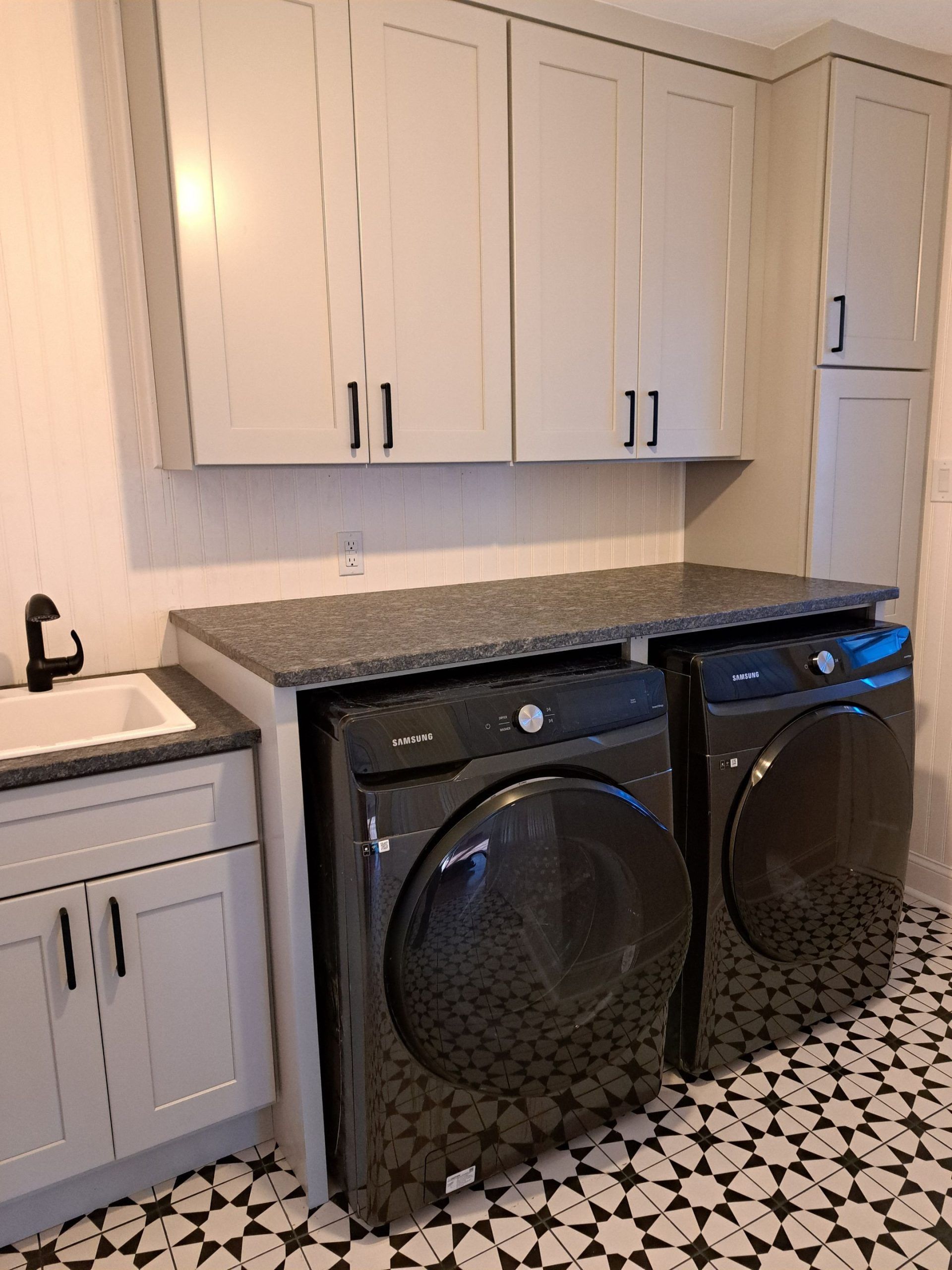 Backyard exterior with wooden deck, stairs, and a newly constructed, wood-paneled extension.