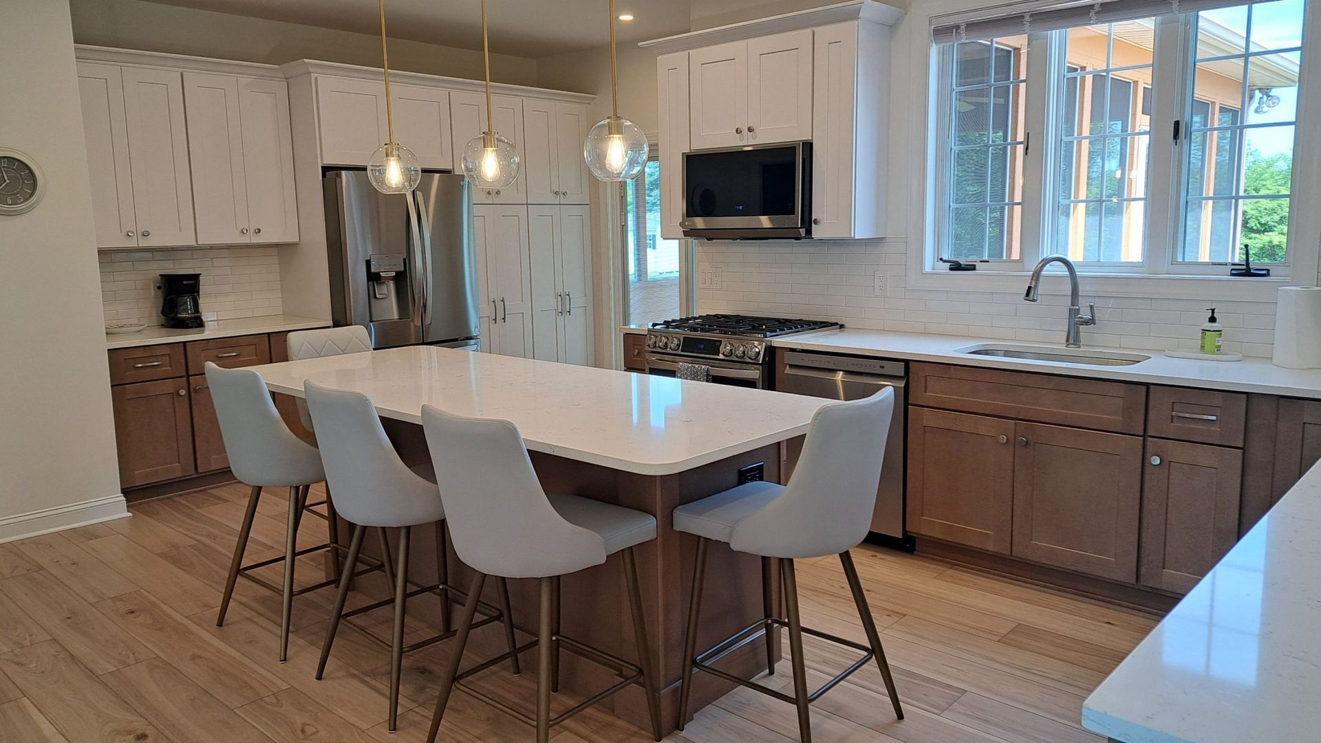 A modern kitchen with a large island, cabinets, and appliances.