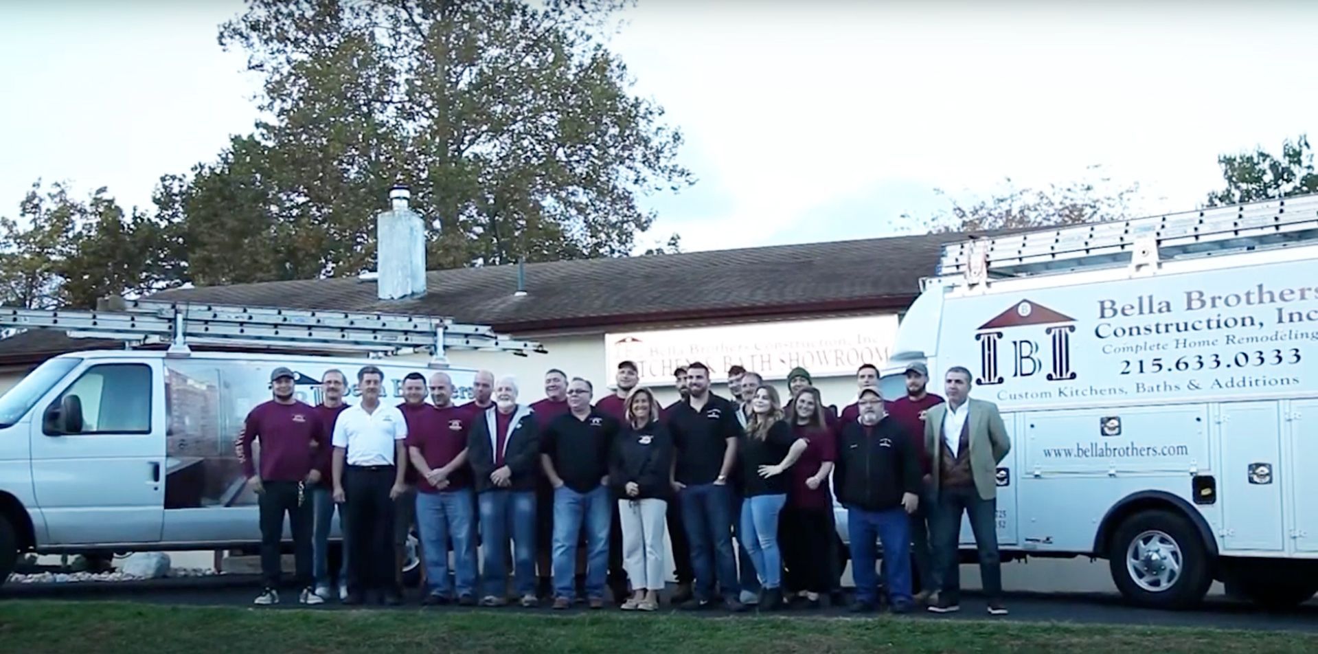 People standing in front of a building and a van.