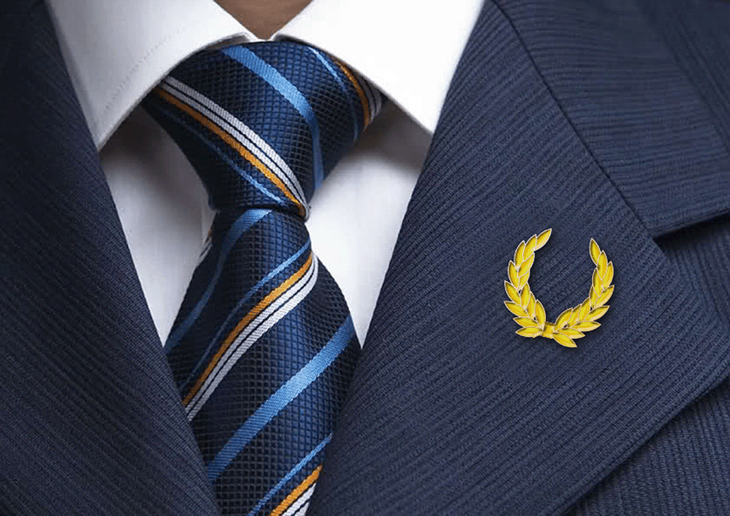 A man in a suit has a laurel wreath pin on his jacket