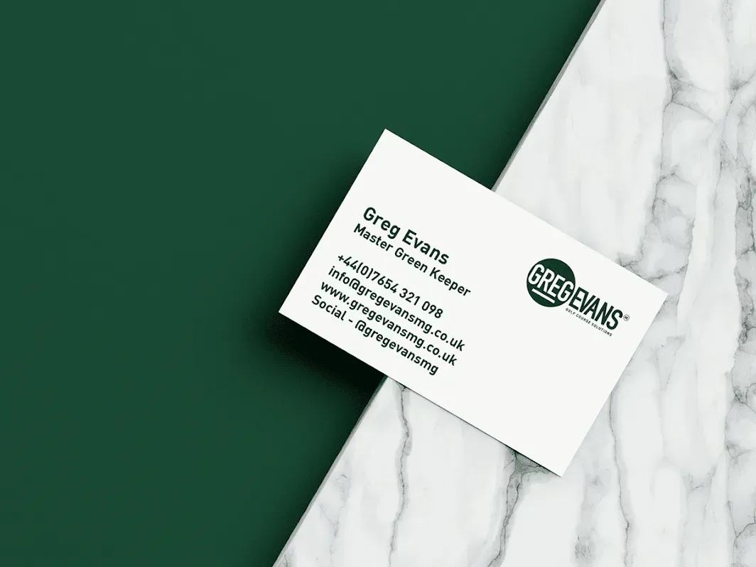 A business card with the name greg evans on it