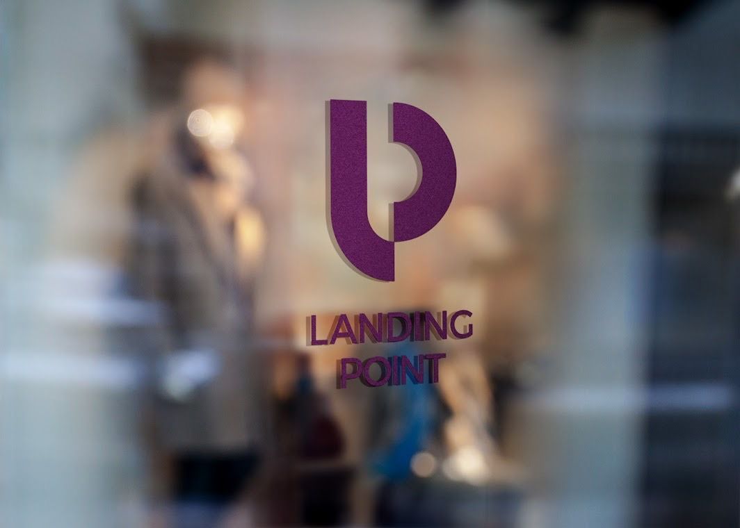 A landing point logo is on a glass window.
