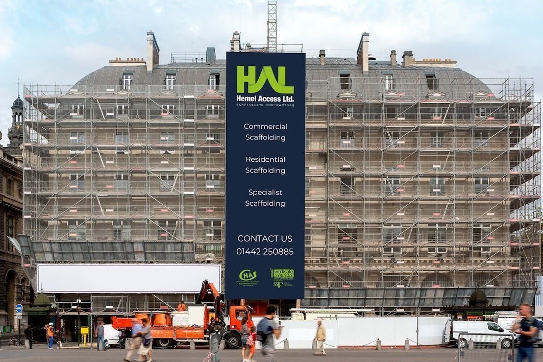 A large building with scaffolding and a sign that says hal