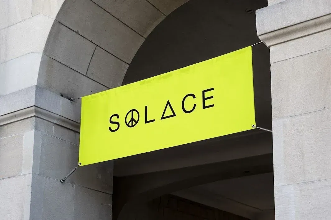 A yellow sign that says solace on it