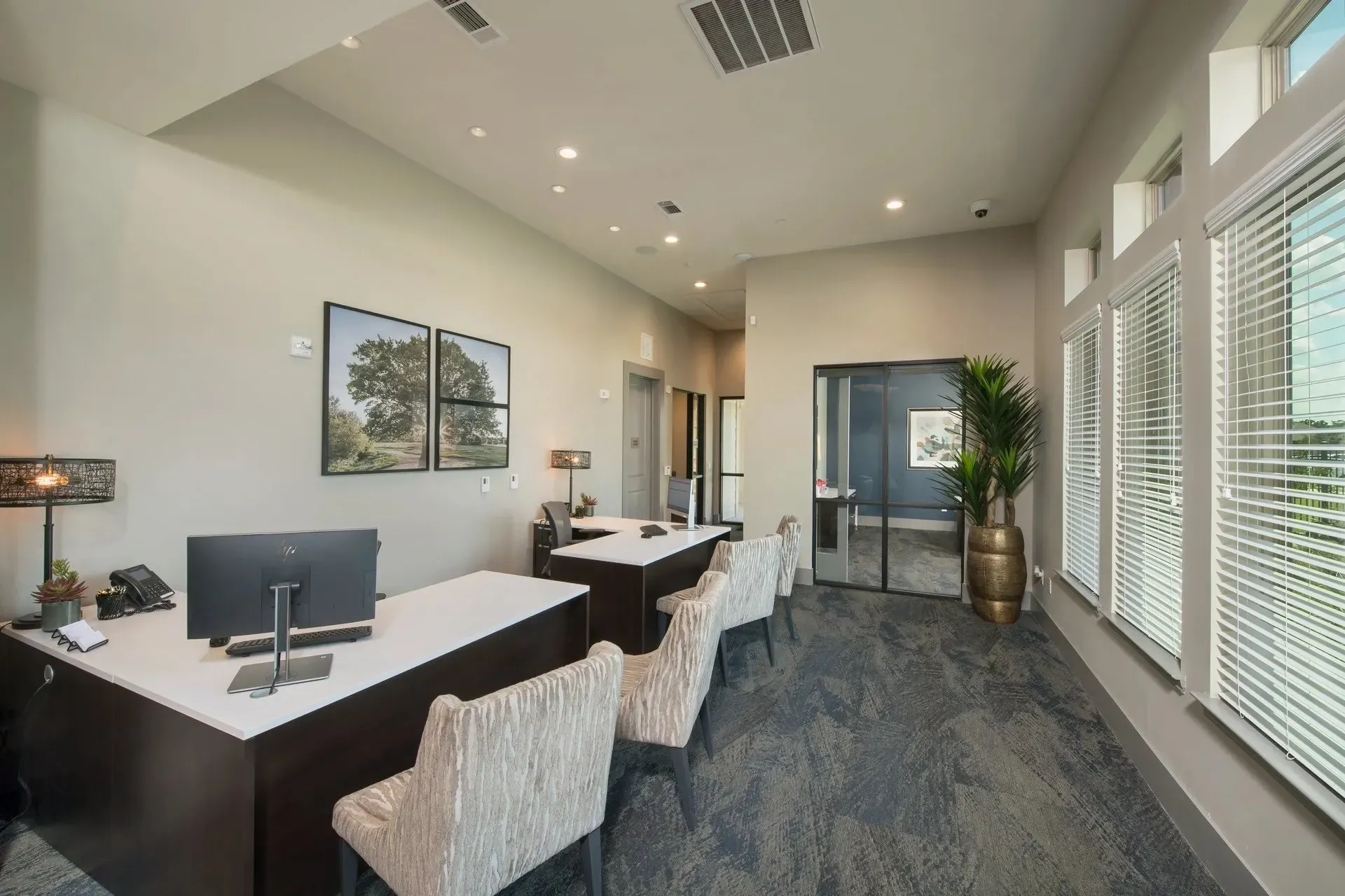 Modern leasing office with desks and large windows