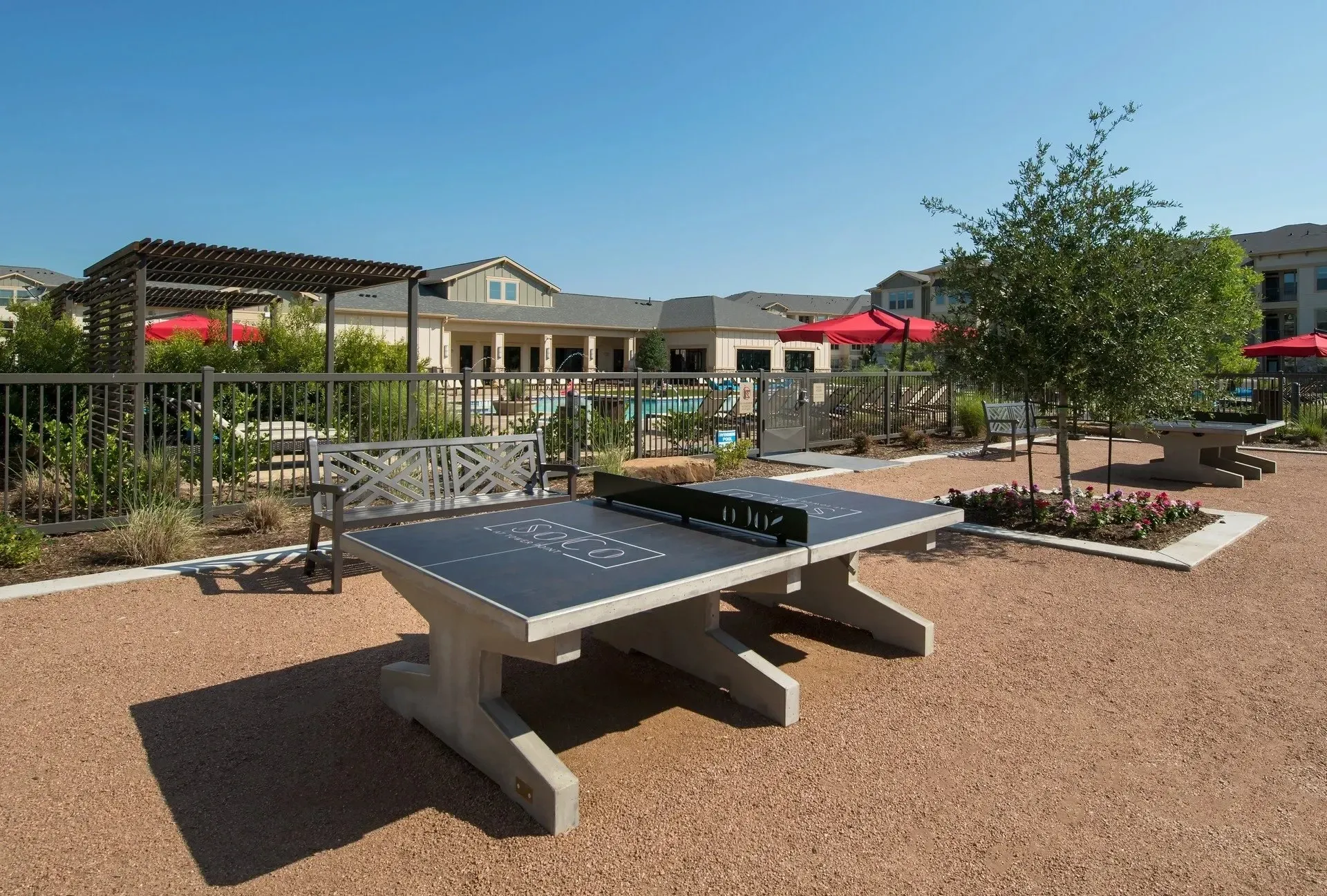 Outdoor recreational area with ping pong tables and seating