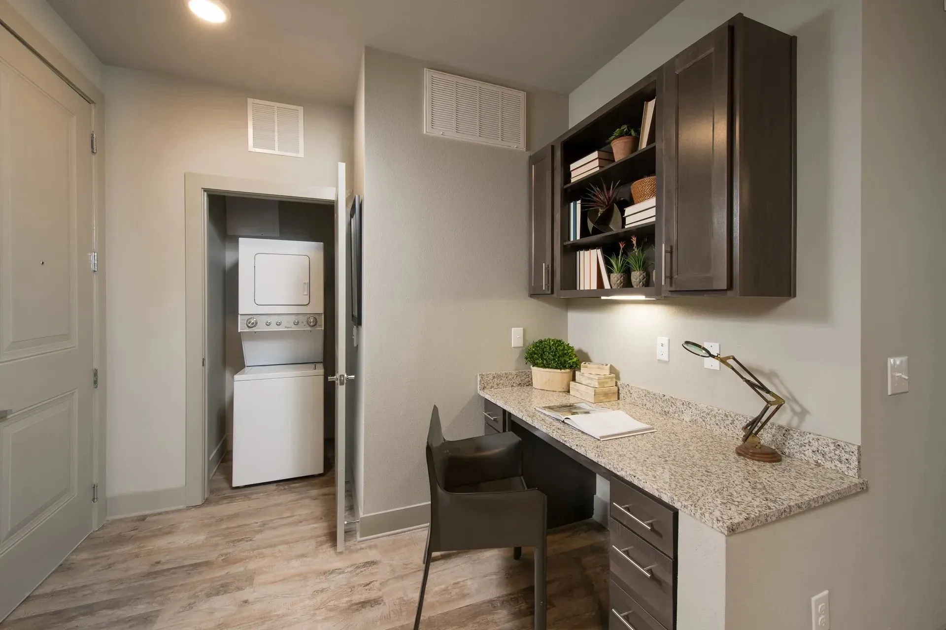Modern apartment workspace with desk and laundry area