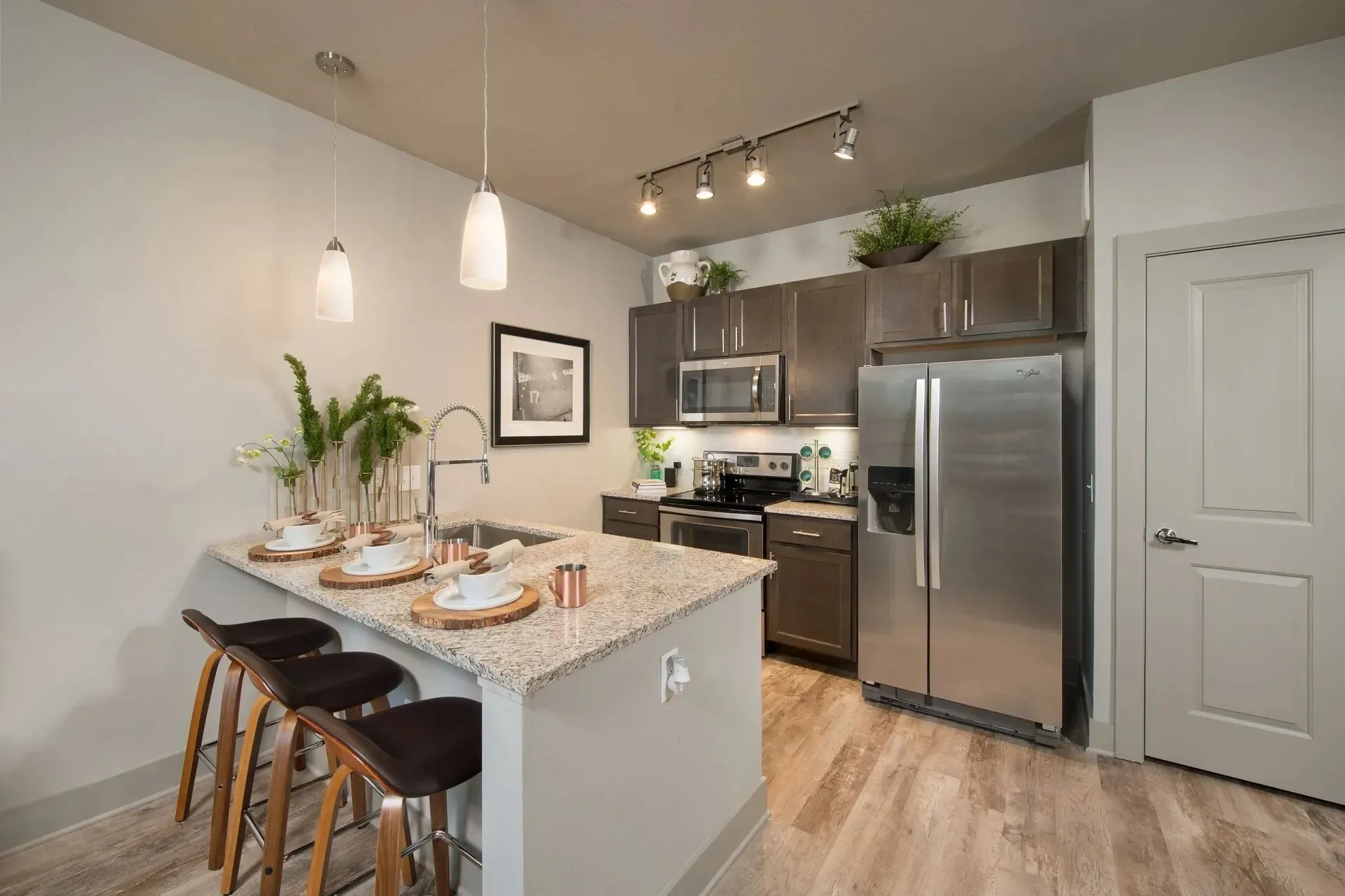 Modern kitchen with granite countertop and stainless steel appliances.