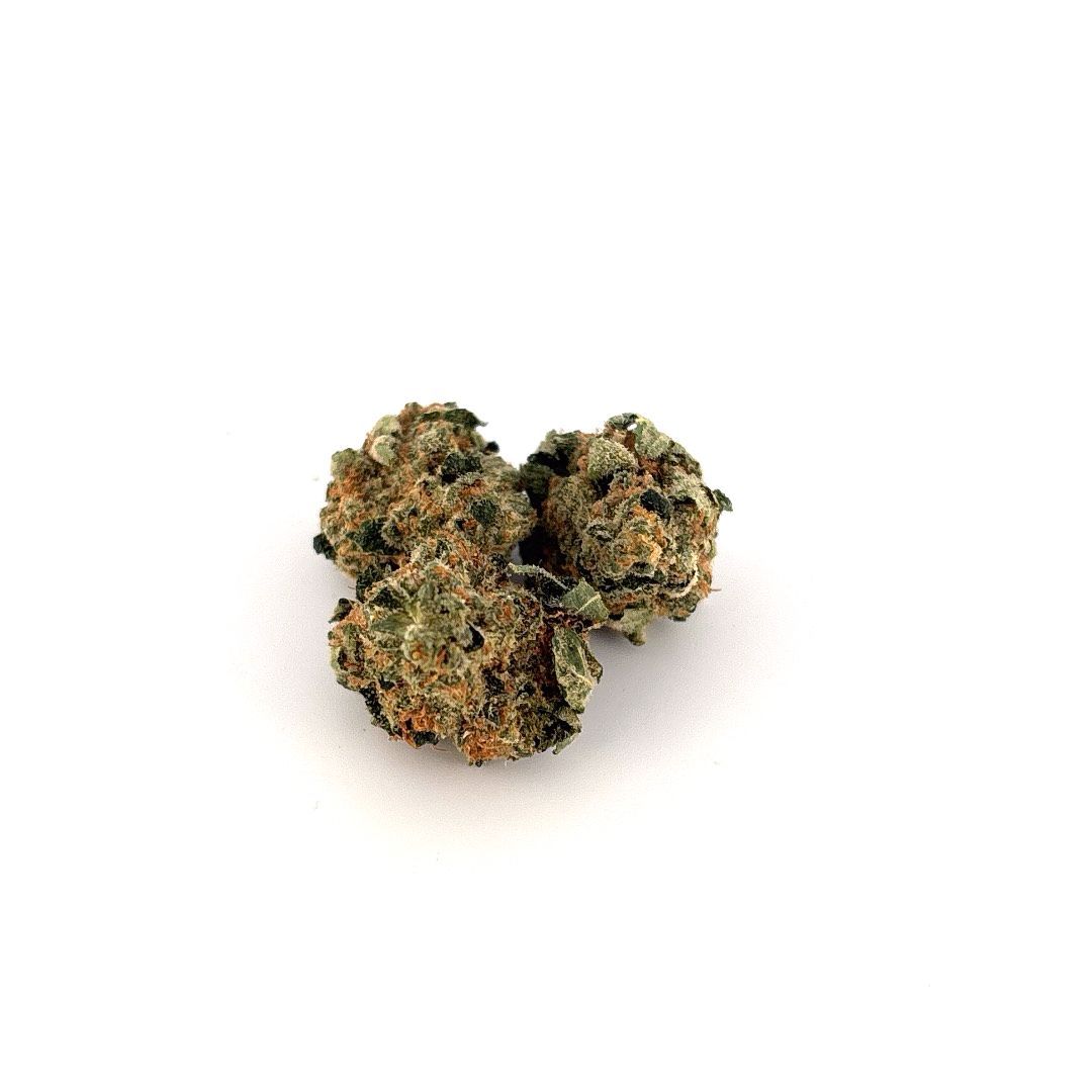 Three cannabis buds on a white background; green with orange hairs and dark specks.