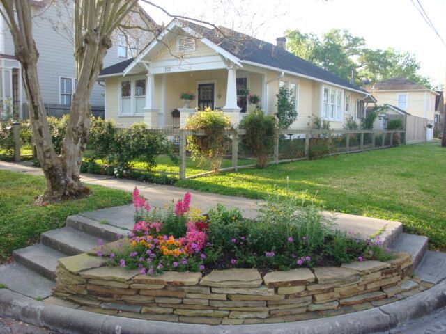 A house with a flower bed in front of it