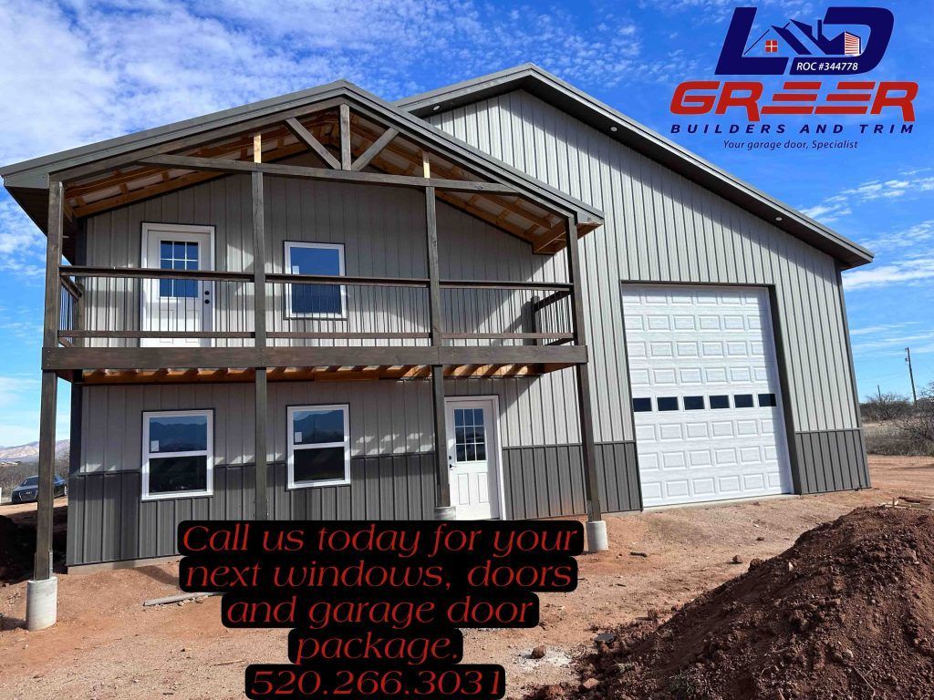 A large metal building with a balcony and a garage door