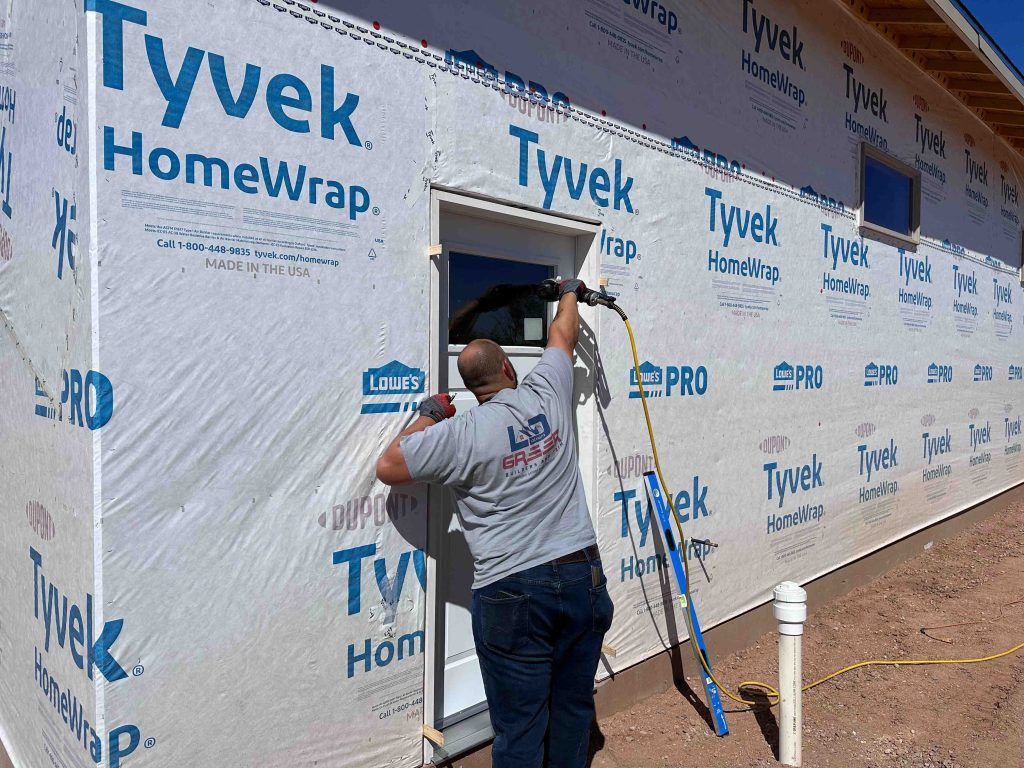 A man is working on the side of a building.