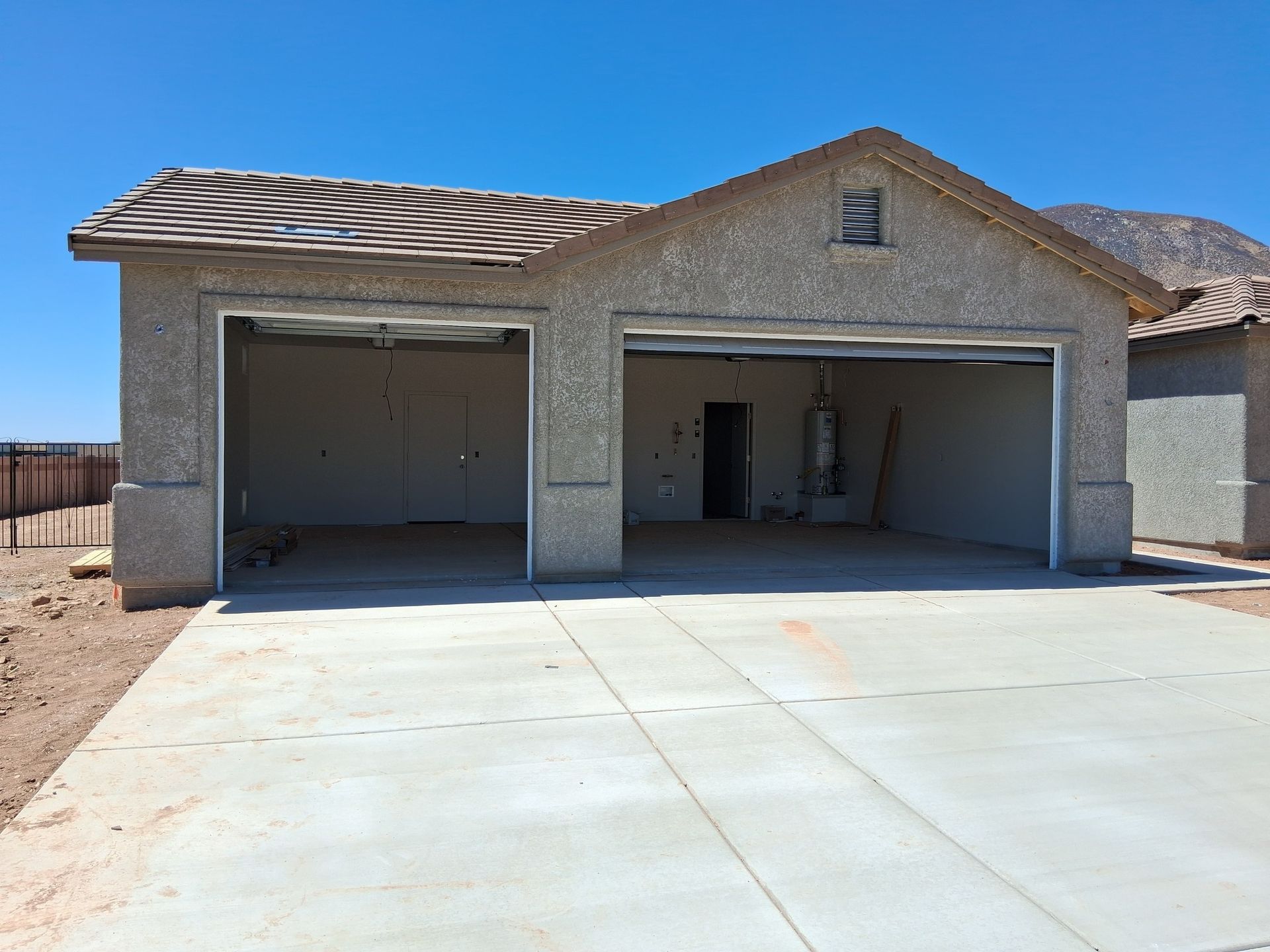 A house with two garage doors that are open