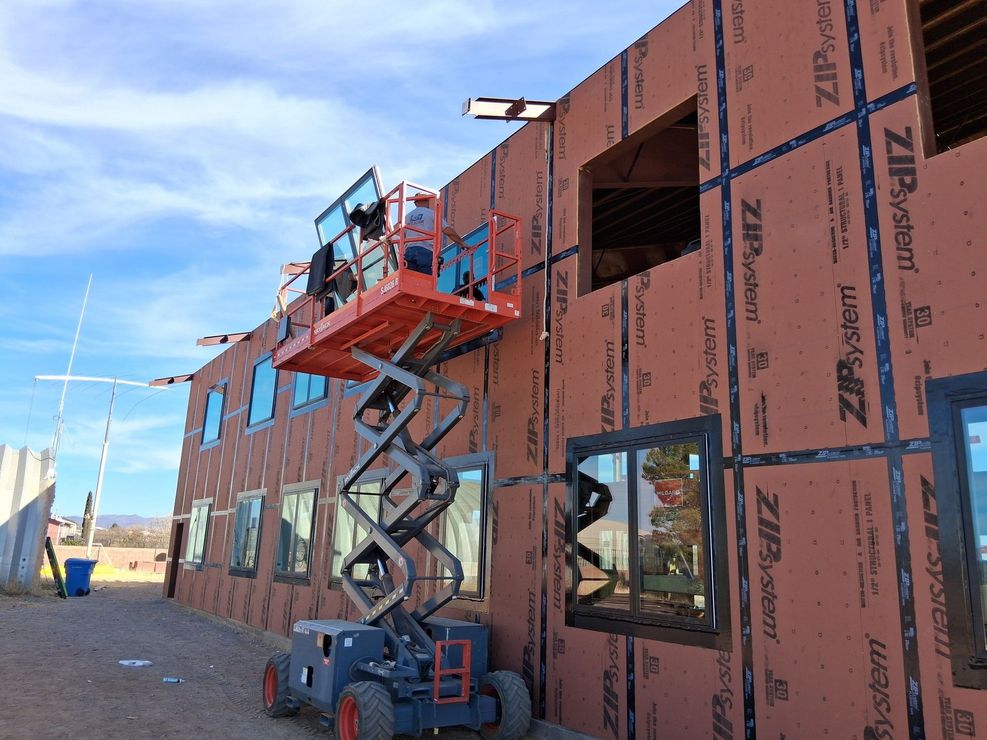 A building under construction with a lift on top of it