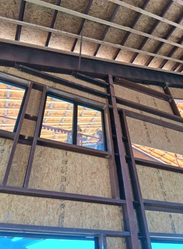 A building under construction with a roof and a lot of windows.