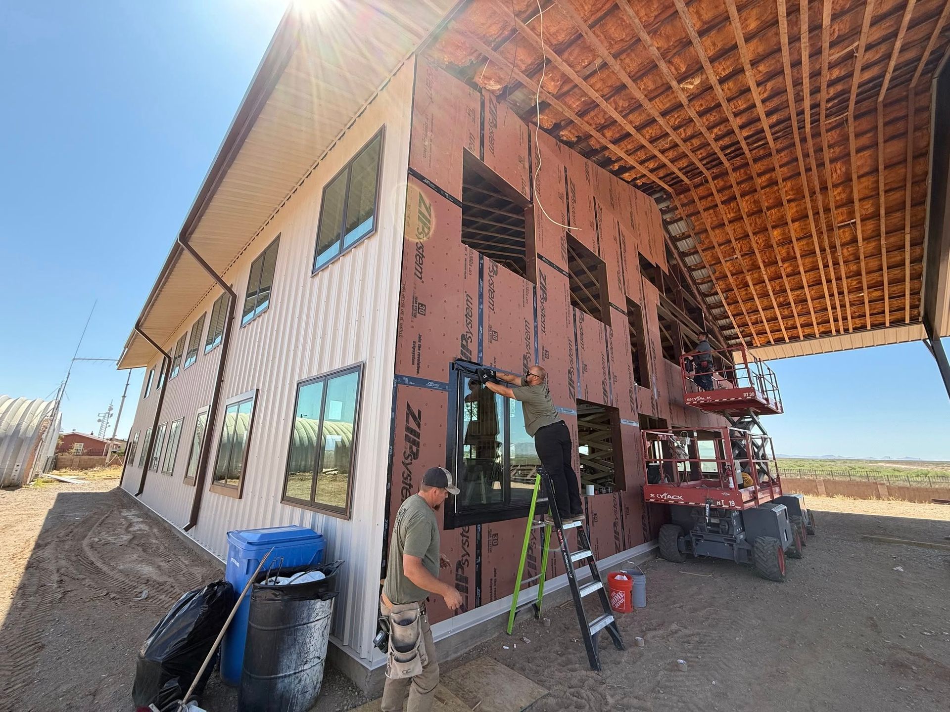 A group of men are working on the side of a building.